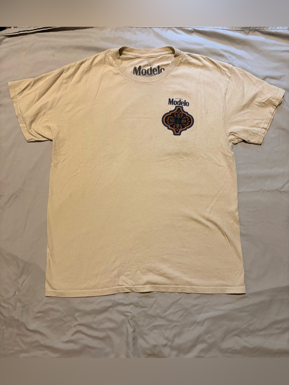 Modelo Cream Tee with Multicolor Chest Emblem